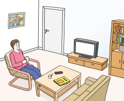 Ein Mann sitzt im Wohnzimmer und trinkt Kaffee